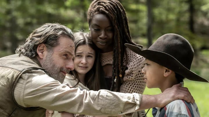 Rick and Michonne hugging Judith and RJ in a scene from The Walking Dead: The Ones Who Live.