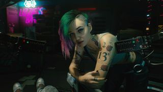 Judy from Cyberpunk 2077 leaning on a table in Lizzie's Bar