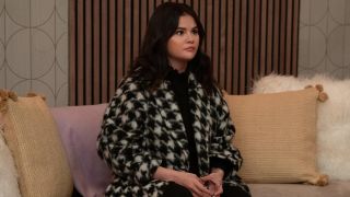 Selena Gomez in Season 3 of Only Murders in the Building sitting on a couch.