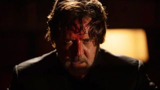 Russell Crowe looking intensely with blood all over his face in 2024's The Exorcism movie