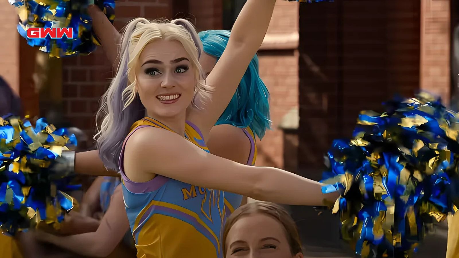 Addison cheerleading with blue and yellow pompoms in school courtyard