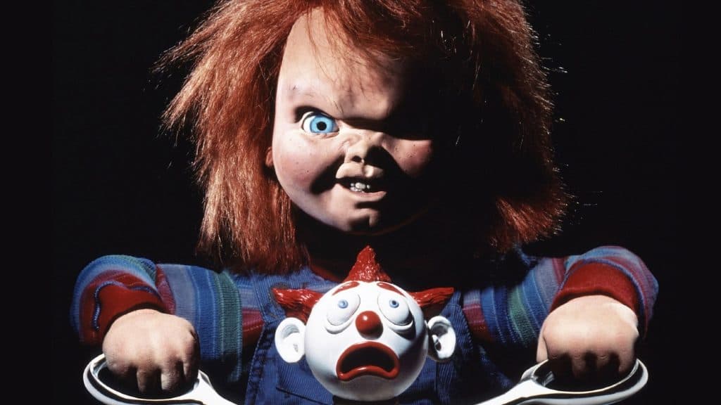 Chucky cutting the head off a clown.