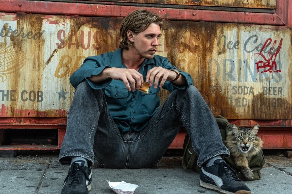 Image may contain Austin Butler Clothing Pants Person Sitting Footwear Shoe Teen Jeans Bread Food and Wristwatch