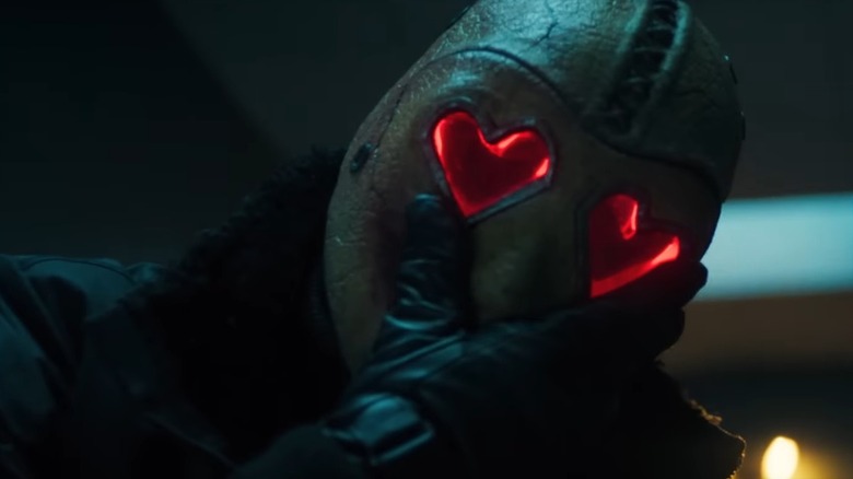 The Heart Eyes Killer grabbing his mask in Heart Eyes