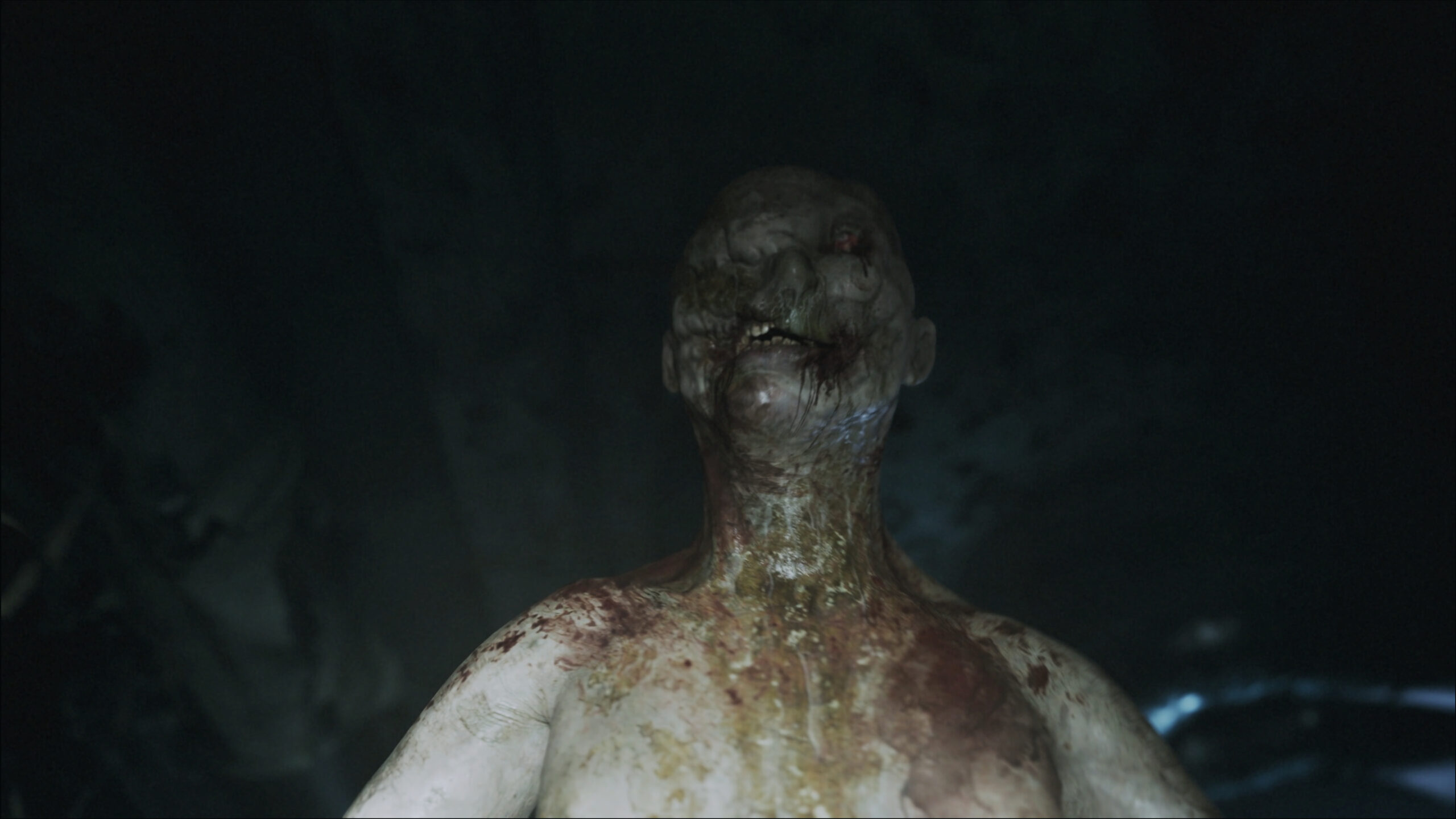 ILL screenshot showing a humanoid figure covered in bodily fluids walking in a very dark corridor