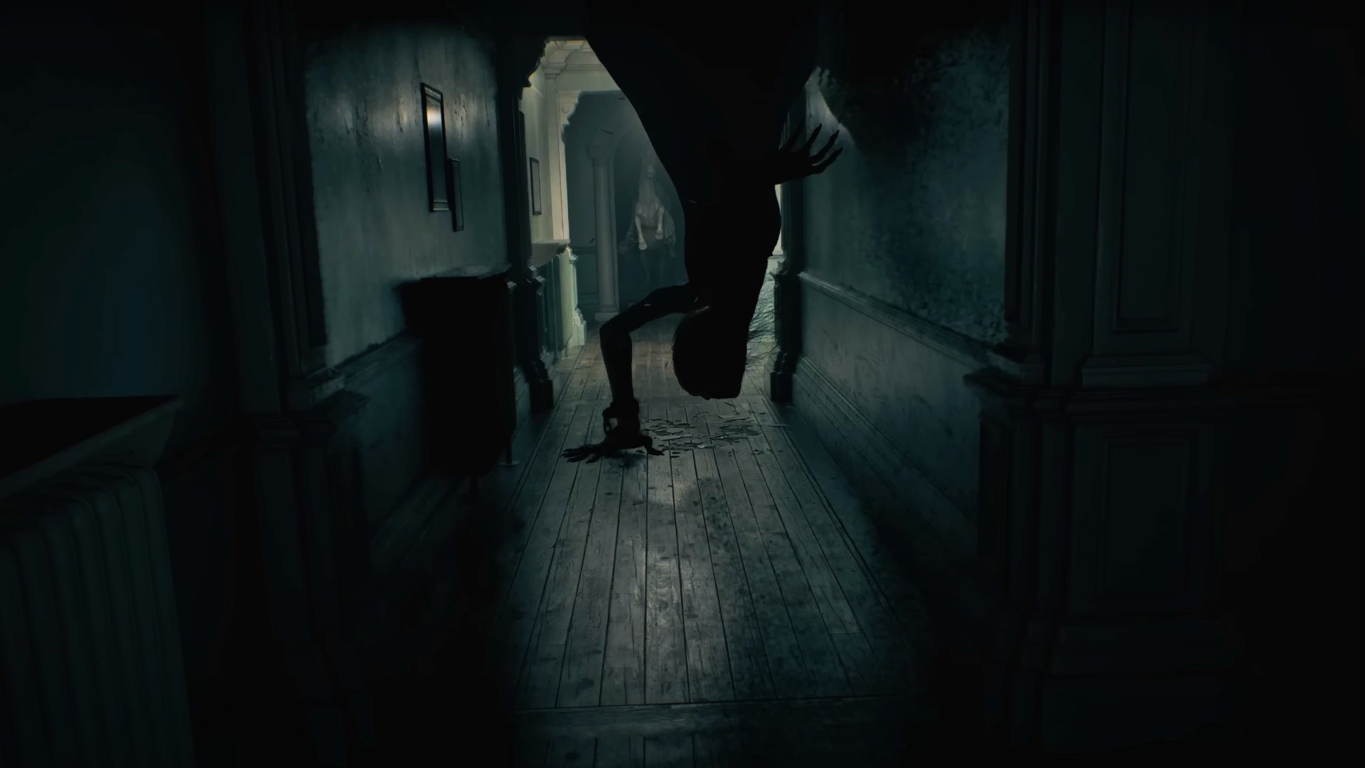 RE9 release date: A mutant crawls down from the ceiling to the floor in what appears to be the Wrenwood Hotel's corridor, a statue of a horse rearing standing in the doorway behind it.