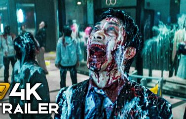 Zombie man with a blood-soaked face screaming in a crowded mall; foreground displays '4K TRAILER' text overlay.